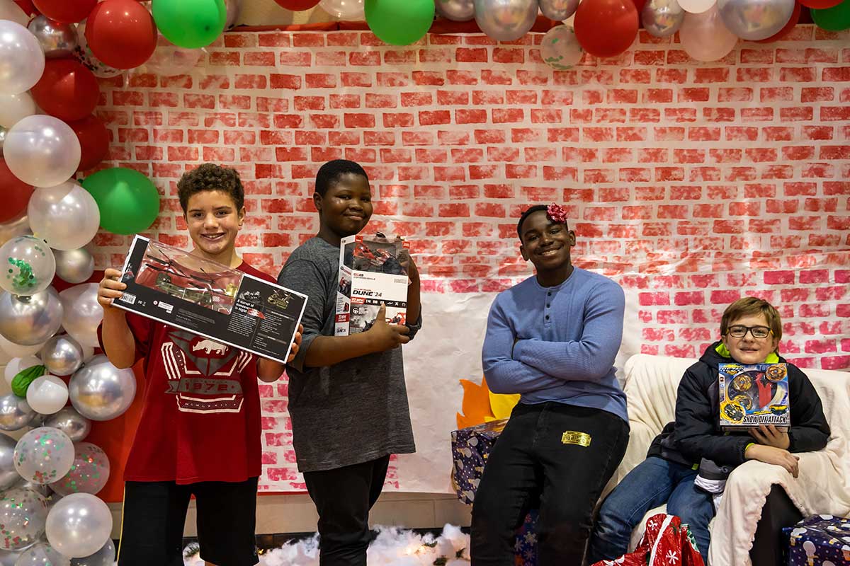 youth with gifts from Holiday Heroes