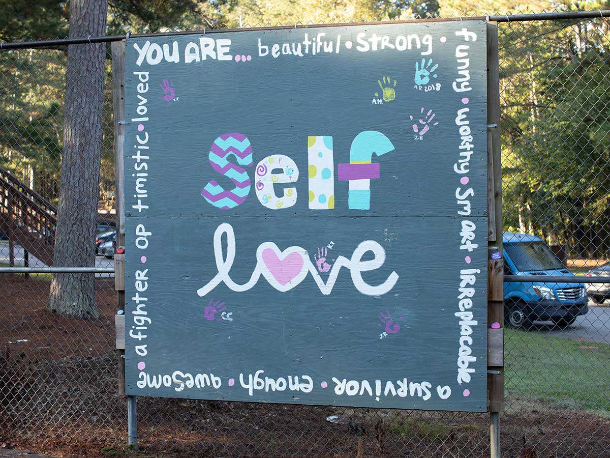 multi color sign saying self love