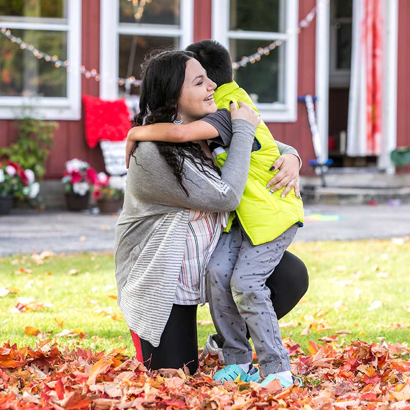 Intercept family, mother and son hugging