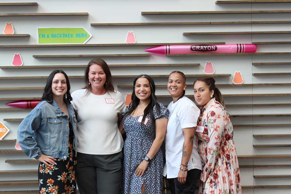 young professionals in front of crayon background