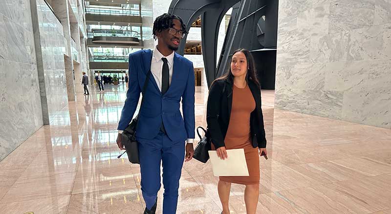 Brandon and Laticia walking down hallway