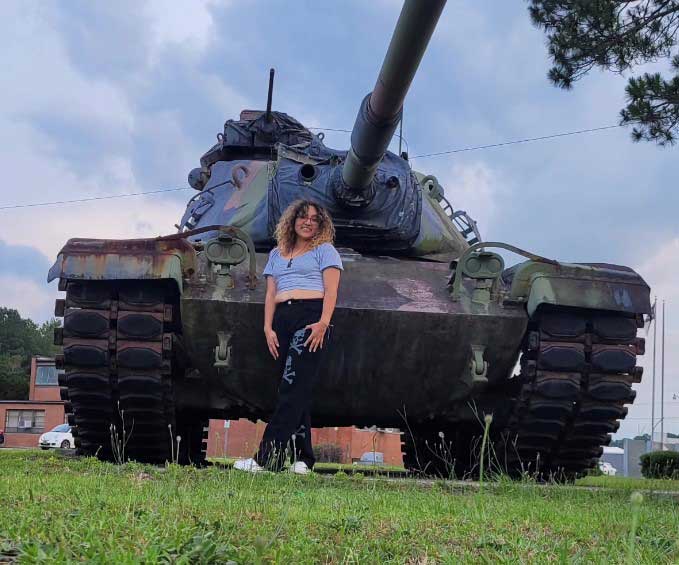 Jimena poses in front of army tank amid dreams of enlisting in military