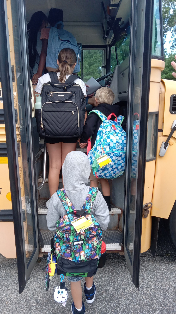 kids getting on school bus