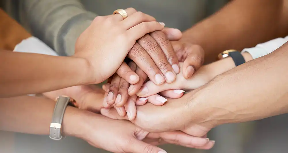 photo of hands stacked on top of each other