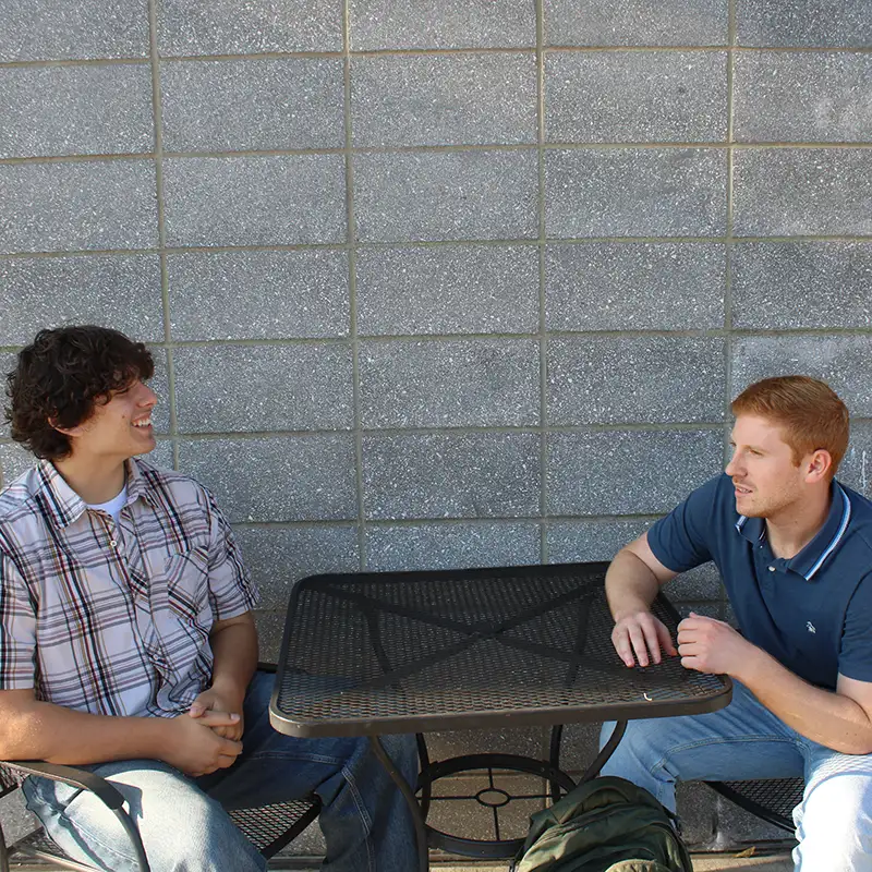 Noah and Elijah sitting at a table talking