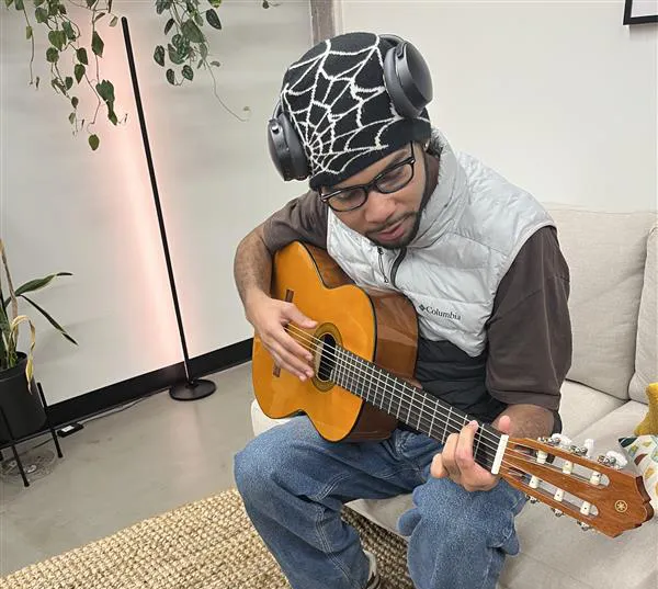 Youth Villages Scholar, DJ, playing guitar