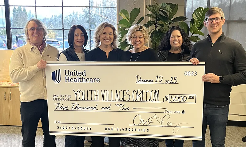 UnitedHealthcare employees present a $5,000 check for Youth Villages during the Holiday Cheers & Volunteers event