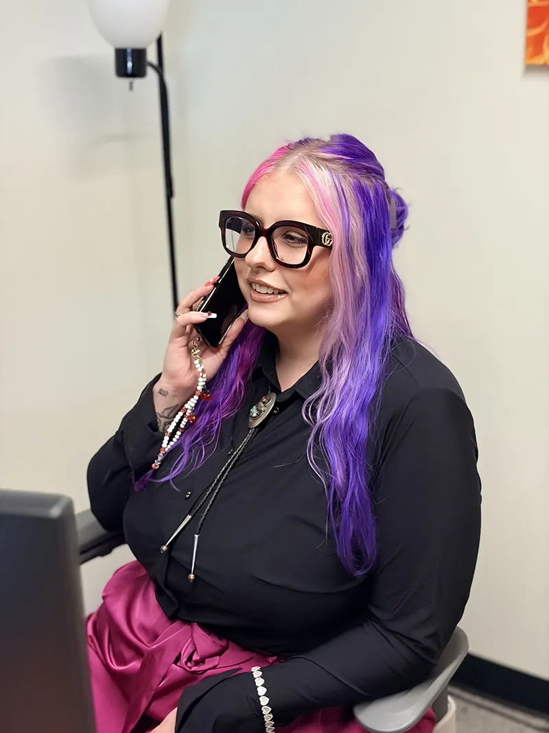 Madi in the office on the phone